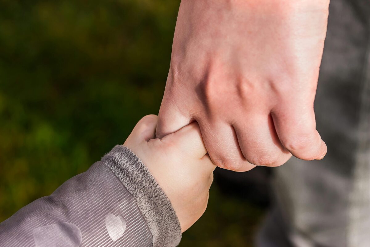 Parent holding child hand — child support and custody guidance